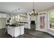Gourmet kitchen with stainless steel appliances, granite countertops, and an island, open to the living room at 6048 Golf View Xing, Locust Grove, GA 30248