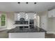 Bright kitchen features a center island, modern light fixtures, and stainless steel appliances at 6048 Golf View Xing, Locust Grove, GA 30248