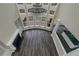 Aerial view of a living room featuring a fireplace, hardwood floors, large windows, and an elegant chandelier at 6048 Golf View Xing, Locust Grove, GA 30248