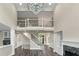 Elegant living room showcasing a fireplace, staircase, and stylish chandelier at 6048 Golf View Xing, Locust Grove, GA 30248