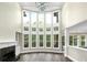 Bright living room featuring hardwood floors, fireplace, and two-story wall of windows at 6048 Golf View Xing, Locust Grove, GA 30248