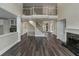 Elegant living room showcasing hardwood floors, staircase, and stylish fireplace at 6048 Golf View Xing, Locust Grove, GA 30248