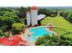 Overhead shot of an expansive community pool with slide and seating, surrounded by trees at 663 Egrets Landing Lot #55, Covington, GA 30014