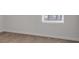 This bedroom is a blank slate, featuring neutral walls, carpet, and a window view at 663 Egrets Landing Lot #55, Covington, GA 30014