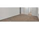 Spacious bedroom with neutral carpet, has two doorways and a view out the window at 663 Egrets Landing Lot #55, Covington, GA 30014