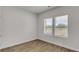 This bedroom is a blank slate, featuring neutral walls, wood floors, and a window view at 663 Egrets Landing Lot #55, Covington, GA 30014
