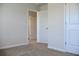 Cozy carpeted bedroom with neutral tones and doorways at 663 Egrets Landing Lot #55, Covington, GA 30014