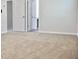 A carpeted bedroom with a pair of doors showing a view into other rooms at 663 Egrets Landing Lot #55, Covington, GA 30014