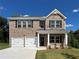 Charming two-story brick home with a two-car garage and manicured front lawn at 663 Egrets Landing Lot #55, Covington, GA 30014