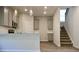 Modern kitchen with granite countertops, stainless steel appliances and stair access at 663 Egrets Landing Lot #55, Covington, GA 30014