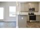 Well-lit kitchen featuring stainless appliances and granite countertops at 663 Egrets Landing Lot #55, Covington, GA 30014