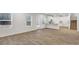 Open concept living room featuring wood-look flooring, natural lighting and seamless transition to kitchen at 663 Egrets Landing Lot #55, Covington, GA 30014