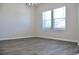 Well-lit room with two large windows and laminate wood floors, providing a serene living space at 663 Egrets Landing Lot #55, Covington, GA 30014
