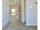 Open-concept living area featuring laminate flooring, and neutral wall, creating a bright and airy ambiance at 663 Egrets Landing Lot #55, Covington, GA 30014