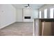 Bright, open-concept living room with hardwood floors and modern fireplace at 663 Egrets Landing Lot #55, Covington, GA 30014