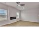 Spacious living room featuring a modern electric fireplace, wood-look floors, and natural light at 663 Egrets Landing Lot #55, Covington, GA 30014