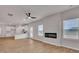 Open-concept living space features a modern fireplace, ceiling fan, wood floors, and plenty of natural light at 663 Egrets Landing Lot #55, Covington, GA 30014
