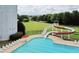 Aerial view of large pool area with waterslide, sun loungers, and umbrellas, a perfect retreat at 663 Egrets Landing Lot #55, Covington, GA 30014