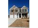Two-story brick home featuring a two-car garage and classic architectural design with a clean blue sky at 669 Egrets Lot 56 Lndg, Covington, GA 30014