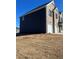 New two-story home with a brick and blue vinyl exterior, and an attached two-car garage at 669 Egrets Lot 56 Lndg, Covington, GA 30014
