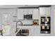 Modern kitchen with stainless steel sink, granite countertops, white cabinets, and double ovens at 669 Egrets Lot 56 Lndg, Covington, GA 30014