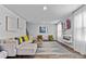 Spacious living room filled with natural light, modern decor, an electric fireplace and comfortable seating at 669 Egrets Lot 56 Lndg, Covington, GA 30014