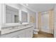 Bathroom featuring double vanity, granite countertop, framed LED mirrors, and shower-tub combination at 669 Egrets Lot 56 Lndg, Covington, GA 30014