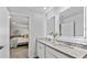 Primary bath featuring granite counters, double vanity, LED mirrors, and access to the main bedroom at 669 Egrets Lot 56 Lndg, Covington, GA 30014