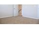 Cozy carpeted bedroom featuring a white door and ample natural light at 669 Egrets Lot 56 Lndg, Covington, GA 30014