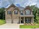 Attractive two-story brick home featuring a two-car garage and manicured front yard at 669 Egrets Lot 56 Lndg, Covington, GA 30014