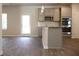 Open-concept kitchen with stainless steel appliances, grey cabinets, and hardwood floors at 669 Egrets Lot 56 Lndg, Covington, GA 30014