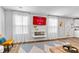 Bright living room with wood floors, modern fireplace, and a view of the backyard at 669 Egrets Lot 56 Lndg, Covington, GA 30014