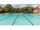 A large swimming pool with lane markers, lounge chairs, and umbrellas at 669 Egrets Lot 56 Lndg, Covington, GA 30014