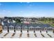 Aerial view of townhomes with garages and stylish exteriors, complemented by a blue sky at 11521 Kimberly Way # 5, Hampton, GA 30228