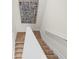 Carpeted staircase with modern artwork leading to the upper level of the home at 11521 Kimberly Way # 5, Hampton, GA 30228