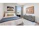 Stylish bedroom featuring a wooden bed frame, gray dresser, and a striped rug, complemented by natural light from the window at 11561 Kimberly Way # 23, Hampton, GA 30228