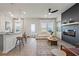 Bright and airy living room with modern fireplace, hardwood floors, contemporary decor, and seamless flow to the kitchen at 11561 Kimberly Way # 23, Hampton, GA 30228