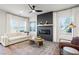 Comfortable living room with a modern fireplace, light-colored sofa, and stylish decor at 11561 Kimberly Way # 23, Hampton, GA 30228