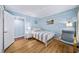 Bedroom featuring light blue walls and hardwood floors at 5141 Roswell Rd # 7, Atlanta, GA 30342