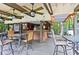 Community outdoor kitchen with ceiling fans, string lights, bar, seating and grill creating an inviting space at 5141 Roswell Rd # 7, Atlanta, GA 30342