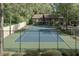 Community tennis court surrounded by lush trees offering residents a recreational amenity at 5141 Roswell Rd # 7, Atlanta, GA 30342