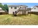 Spacious backyard featuring a two-story deck, perfect for outdoor entertaining and enjoying the serene surroundings at 6367 Deshong Dr, Lithonia, GA 30058