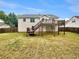 Expansive backyard with a charming two-story deck, offering ample space for recreation and relaxation in a private setting at 6367 Deshong Dr, Lithonia, GA 30058