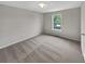 Cozy bedroom with neutral carpet, a window, and a closet door for ample storage at 6367 Deshong Dr, Lithonia, GA 30058