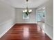 Bright dining room featuring a modern chandelier and beautiful hardwood floors at 6367 Deshong Dr, Lithonia, GA 30058