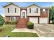 Charming two-story home featuring a brick facade, two-car garage, and well-maintained landscaping at 6367 Deshong Dr, Lithonia, GA 30058