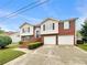 Charming two-story home featuring a brick facade, two-car garage, and well-maintained landscaping at 6367 Deshong Dr, Lithonia, GA 30058