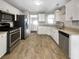 Bright kitchen with stainless steel appliances, white cabinets, and granite countertops at 6367 Deshong Dr, Lithonia, GA 30058