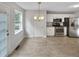 Open-plan kitchen and dining area with stainless steel appliances and bright tile floors at 6367 Deshong Dr, Lithonia, GA 30058