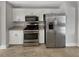 Bright kitchen featuring stainless steel appliances and white cabinets at 6367 Deshong Dr, Lithonia, GA 30058